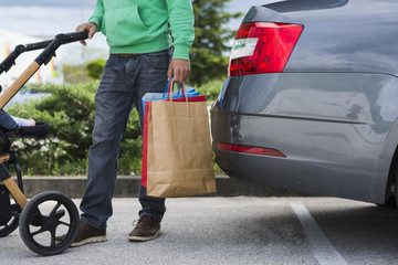 Person keeping shopping bags inside the car