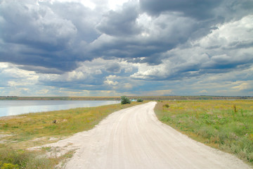 Fototapeta na wymiar road through the steppe to the camp on the estuary.
