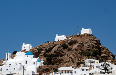 Greece, Cyclades, Ios. Three old chapels atop the hill that towers over the old village, the hora....