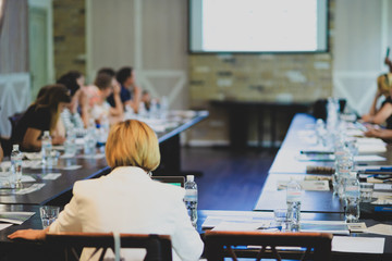 People sitting at the table at a business conference.