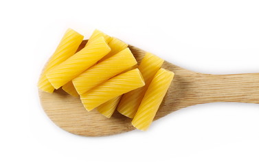 Pasta tubes, tortiglioni or elicoidali with wooden spoon isolated on white background, top view