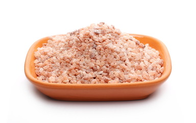 Himalayan salt grains, crystals in clay pot, bowl isolated on white background