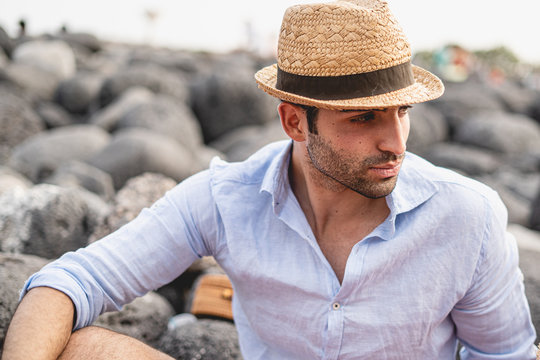 fashion guy wearing a hat on the seaside. Lifestyle leisure activities concept