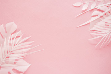 Tropical palm leaf on pink background. Flat lay, top view