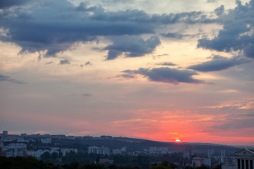 sunset and low clouds over the city