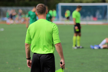 The line referee observes the situation on the football field