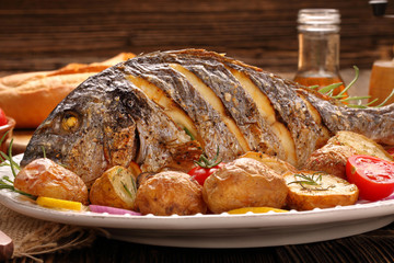 Roast Dorada on a wooden background