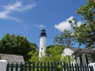 Wide shot of the Key West lighthouse  and the keeper's quarters. The lighthouse is a historical attraction in Key West, Florida.