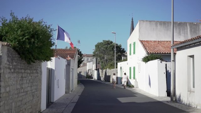 Ile de R&eacute; - France. Little village with french flag in the wind. Ars en R&eacute; - lovely village