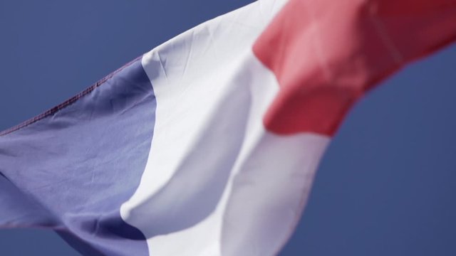 French flag in slow motion - dynamic motion with beautiful light. Cinematic French flag in the wind