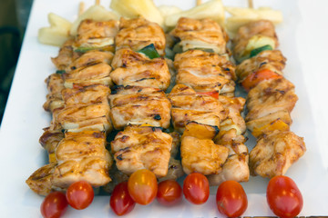 Assorted meat from chicken and pork and various vegetables on barbecue grill 