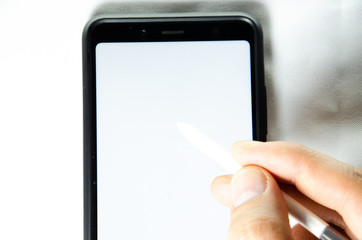 Electronic signature by a male hand on a smartphone with a black frame on a white background close, top, side