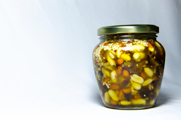 Nuts and assorted nuts in a jar of honey and brown bread with cereals