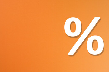 Percentage sign on orange background with copy space