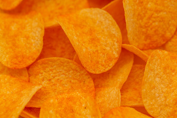 Crispy potato chips snack texture background. Close up potato chips, top view. Selective focus, shallow depth of field.