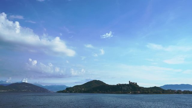 Italian castle Rocca di Angera Timelapse iconic view. Cinematic time lapse of the caste with the lake in the foreground