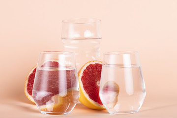 Fototapeta na wymiar Arrangement with water glasses and red oranges