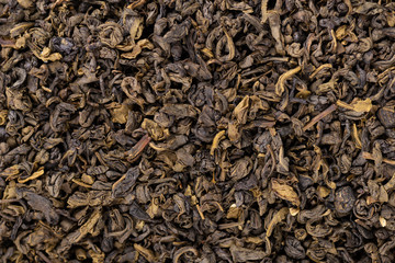 Green tea background. Aromatic green dry tea, close up.