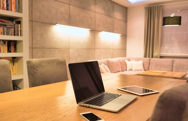 Photo of gadgets placed on table at home