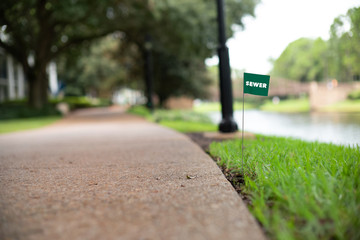 Sewer and drain lines stake flag buried underground utility