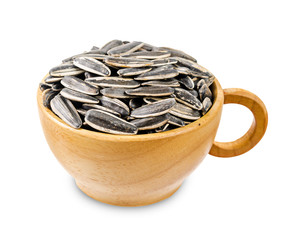 Dried ripe sunflower seeds in wooden cup.