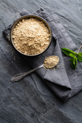 Dietary supplement, Maca root powder in a bowl and spoon with copy space