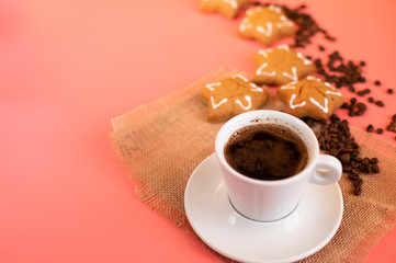 Coffee Cup gingerbread and coffee beans on pink background.