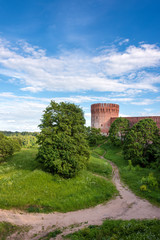 Fototapeta na wymiar Footpath under the Smolensk ancient fortified walls on a sunny summer day