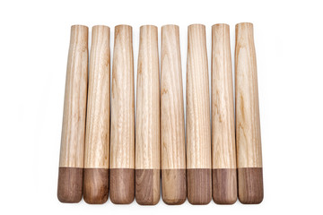 Furniture legs from solid ash and walnut on a white background. Kids furniture. Furniture details