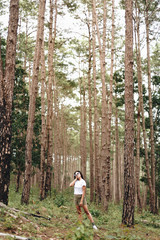 Young Asian woman in the forest, nature travel concept