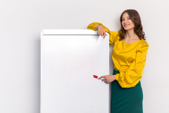woman teacher in the classroom shows a red marker on a white Board against the wall. mocap whiteboard