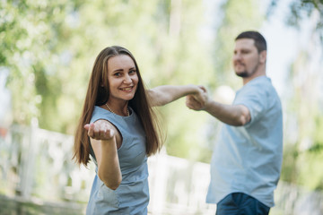 Happy couple flirting and holding hands in park