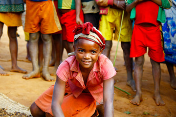 Obraz na płótnie Canvas Very pretty malagasy child smiling in the vilage- poverty