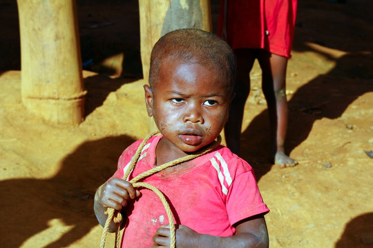 Poor african boy with a string - is he trying to attempt a suecide?