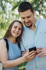 Couple listening to music on smartphone in park