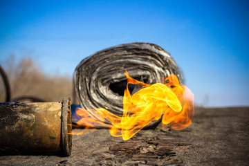 Roll roofing Installation with propane blowtorch during construction works