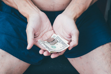 Close up of poor man hand with small money