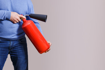 Man using fire extinguisher to stop fire. Concept of protection and security. Space for text