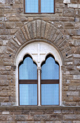 Old ancient window on stone facade