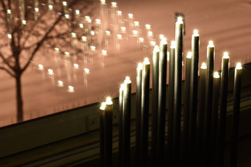 Electric candles by the clear glass window during Christmas season.