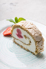 Slice of ice cream roll cake served with strawberry