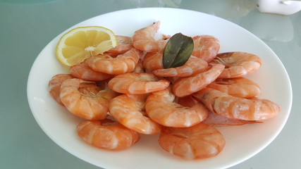 Kitchen and food, cooked shrimp, shrimp in a plate. Boiled shrimp with lemon. roasted prawns on white plate,
