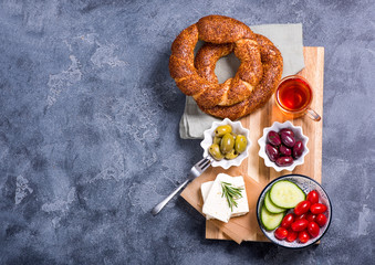 Traditional turkish breakfast with olives, simit bagels, feta cheese, tea,  copy space text background - obrazy, fototapety, plakaty