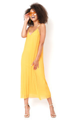 Happy, beautiful girl in yellow dress on set.