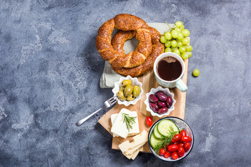 Traditional turkish breakfast with olives, simit bagels, feta cheese, coffee, copy space background