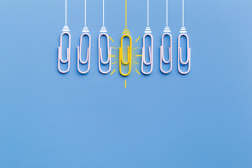 Great ideas concept with paperclip,thinking,creativity,light bulb on blue background,new ideas concept.