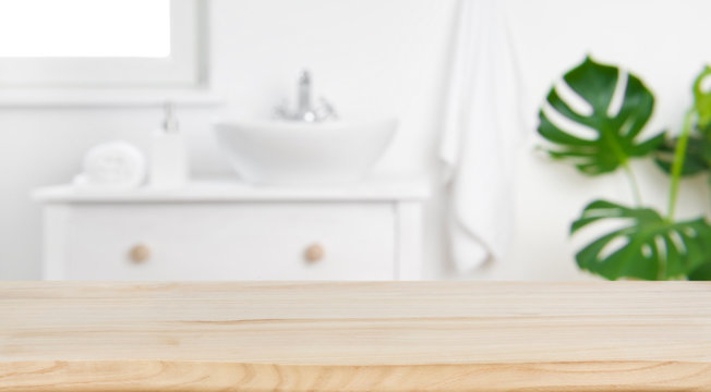 Wood tabletop on blur bathroom background, design key visual layout