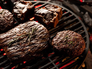 Top view meat steak assorted cooking on grill background.