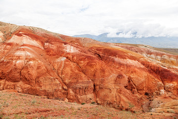 A stunning panorama of a mountain chain of peaks, a canyon with red clay, top view. Mars fields in Altai, Russia. fantastic clay castles in the sandy desert of the red canyon