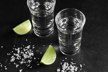Close up vodka in shot glass on black background, Russian vodka with salt and lemon